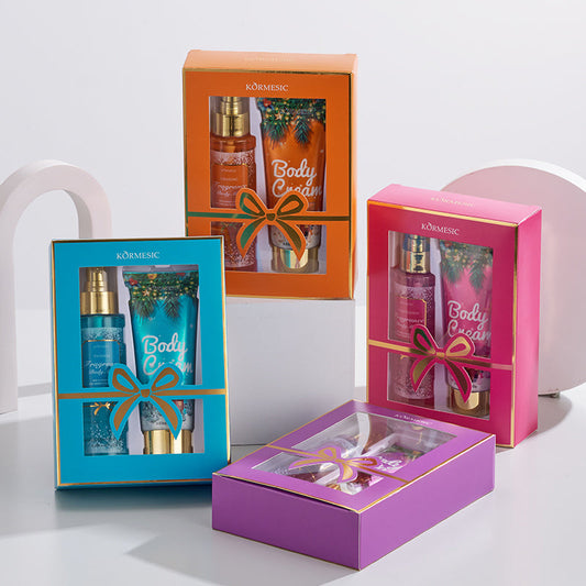 Fragrance body care set with orange and pink gift boxes and open purple tray