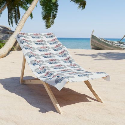 White beach towel draped on wooden stand, red and blue script pattern