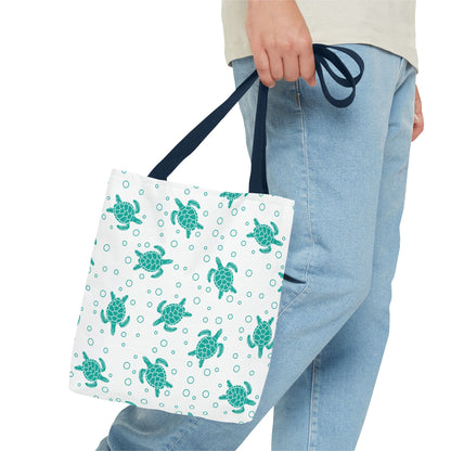 Sea turtle print tote bag with teal turtles on white, navy carry handles