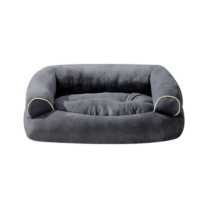 Dark gray fabric pet sofa bed with curved side bolsters and beige piping trim.