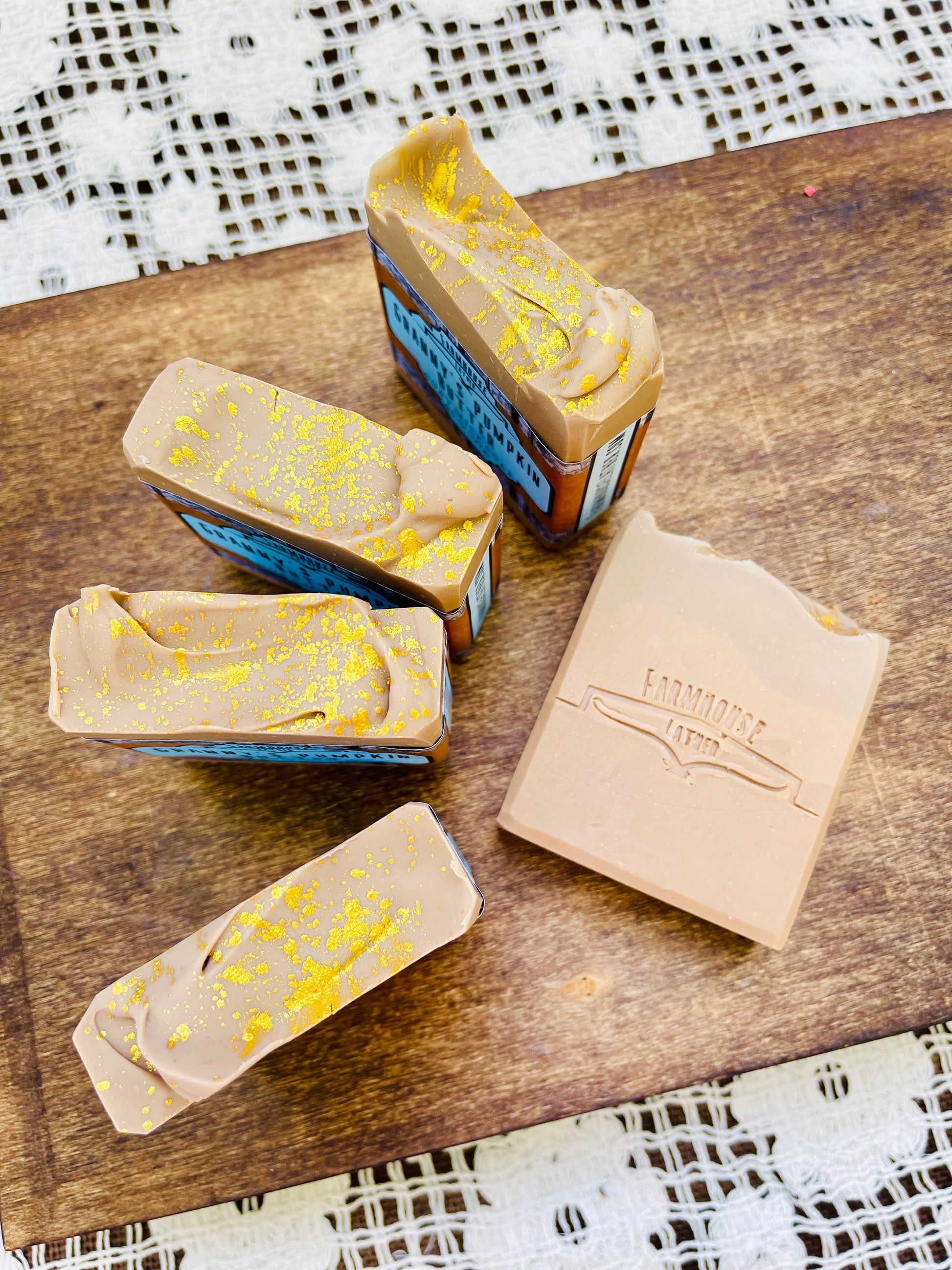 Pumpkin butter soap bars with blue edges and yellow speckle, plus beige box