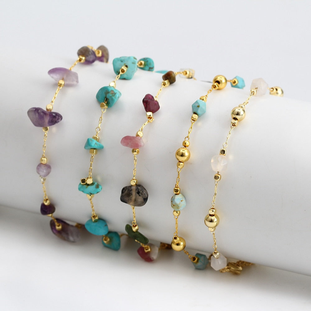 Gold-tone charm bracelets with dangling beads and heart charms in mixed colors
