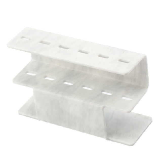 Dirty white acrylic eyelash tweezer holder with two shelves and slot openings
