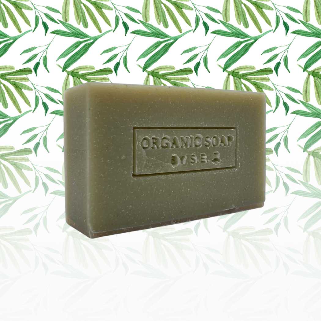 Organic bar soap, olive green bar with embossed label and speckled texture.