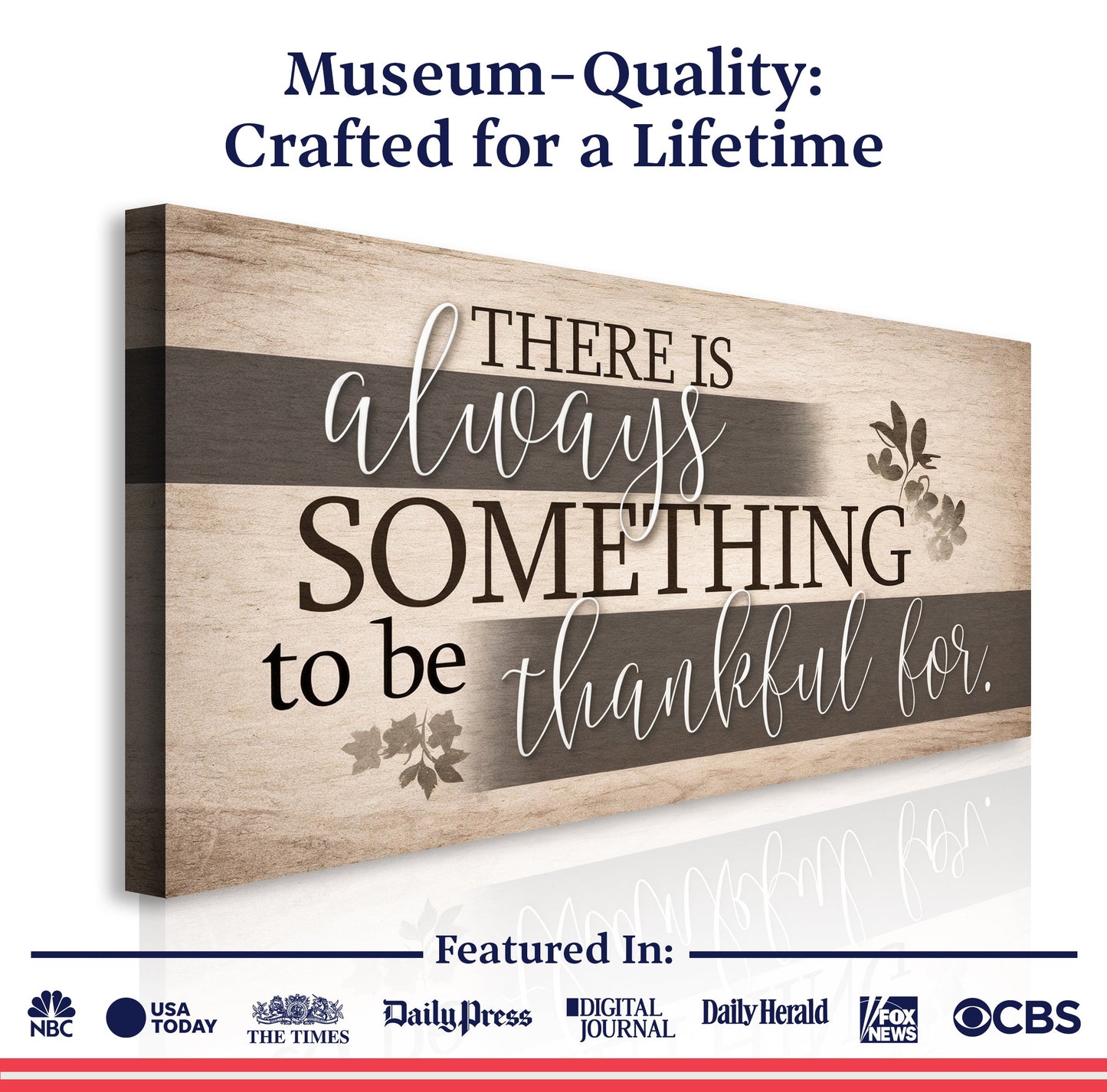 Wall sign close-up with “There is always something to be thankful for.” on beige and dark gray stripes.