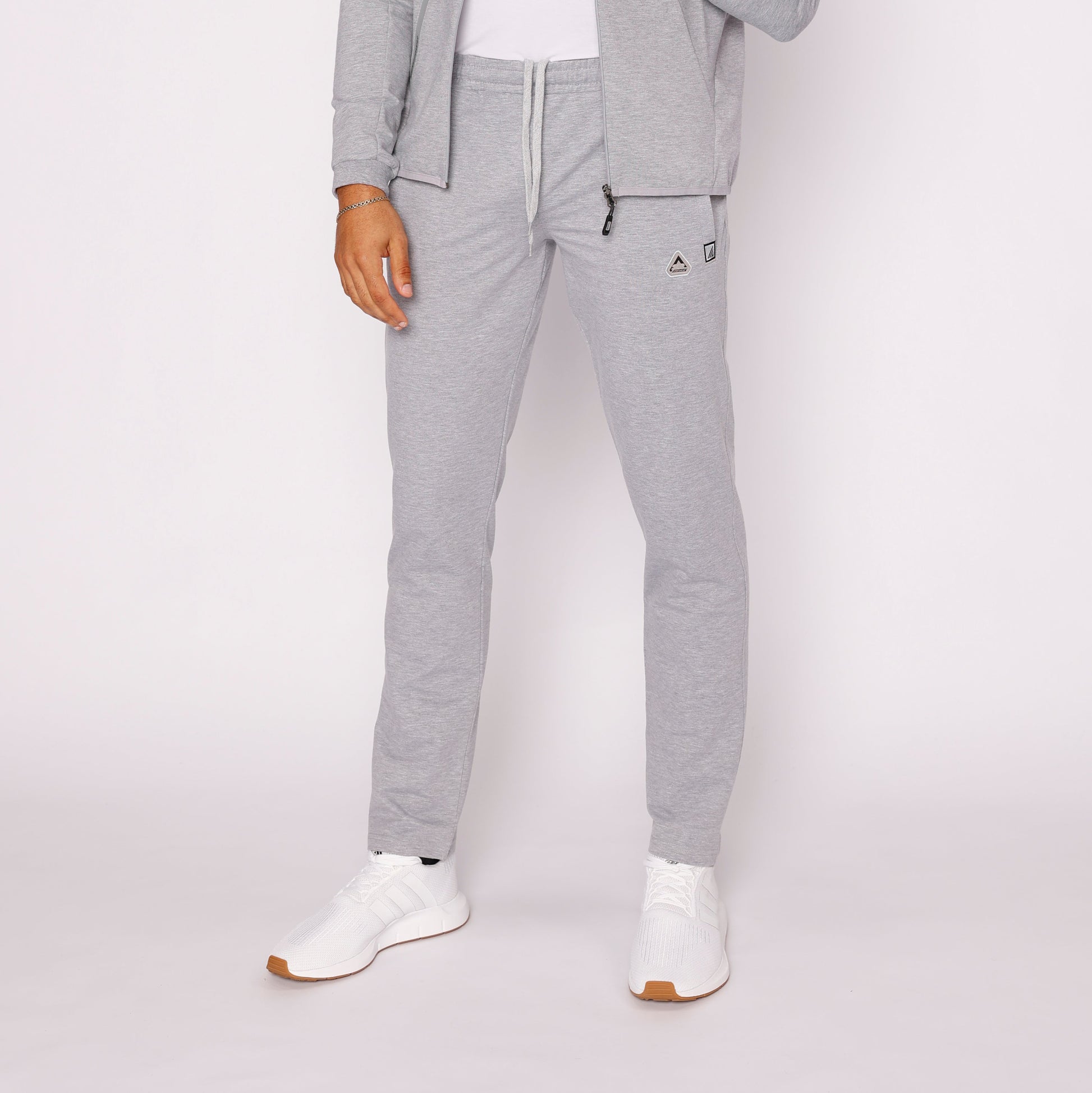 Light gray tapered sweatpants with zip pocket and drawstring waistband