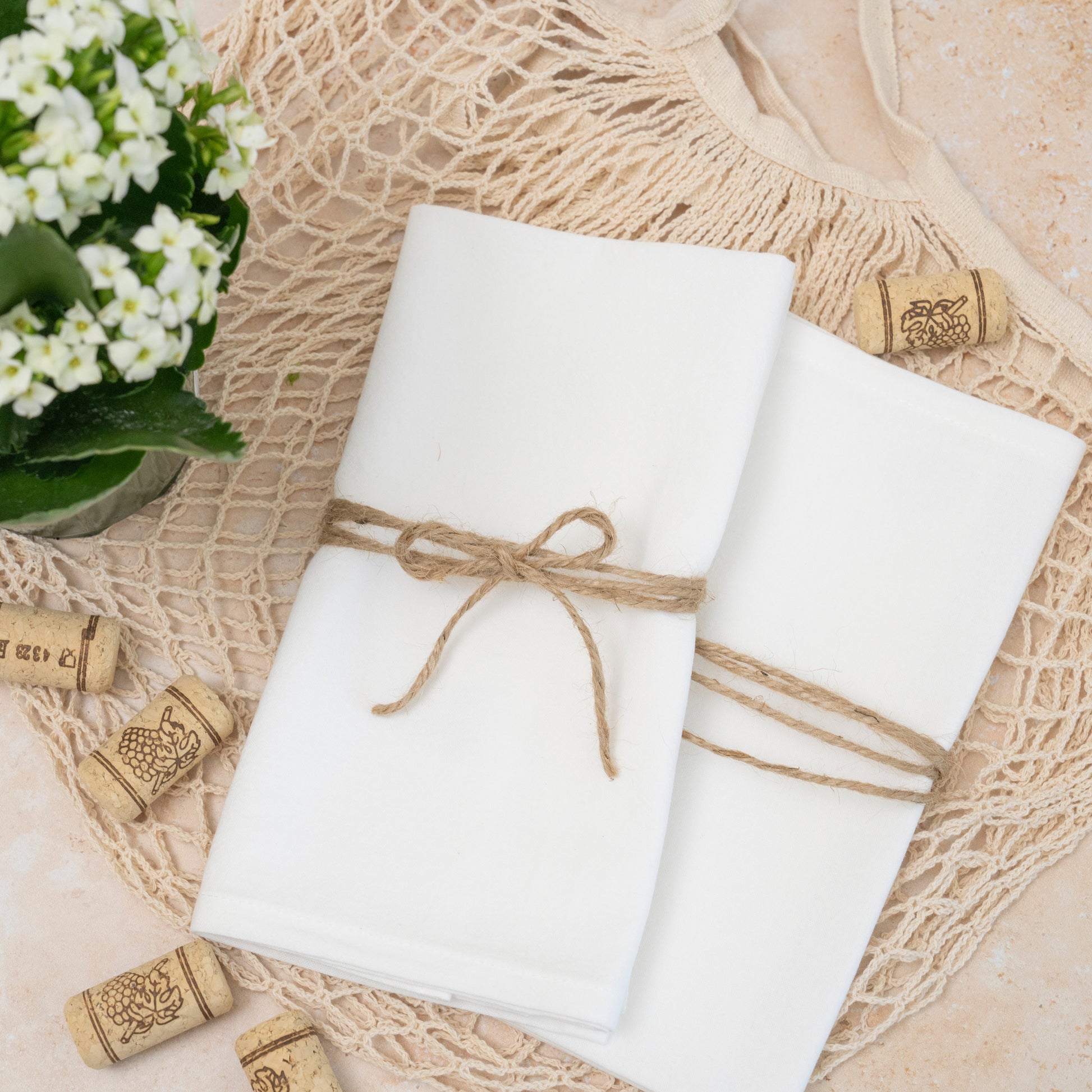 Flour sack napkins, white, neatly folded and tied with twine