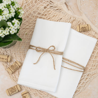 Flour sack napkins, white, neatly folded and tied with twine