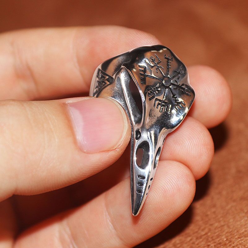 Silver gothic ring held in hand with engraved snowflake motif