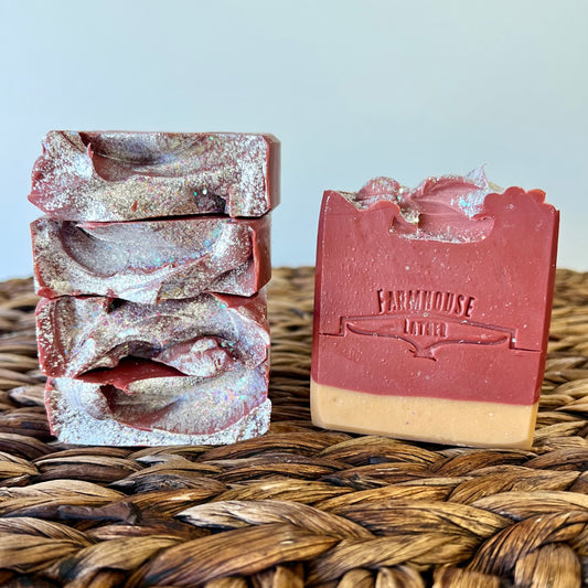 Two scented soap bars, silver-red swirled and pink-red with stamped label