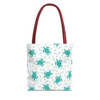 Sea turtle pattern tote bag with teal repeating turtles and red carry handles