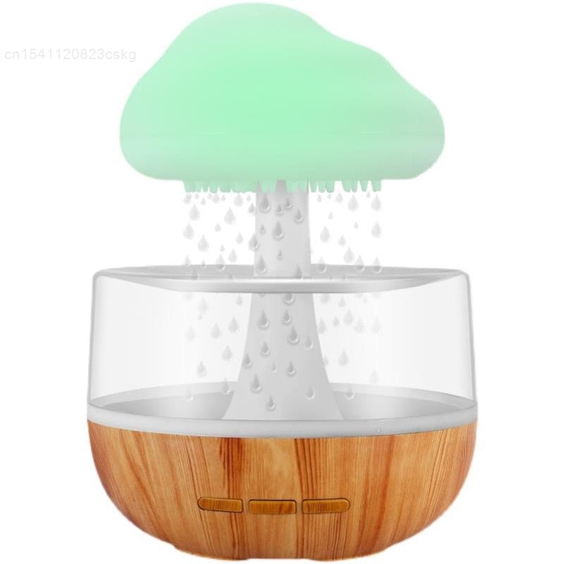 Rain-cloud desktop humidifier with light wood base, mint top, visible raindrop nozzles