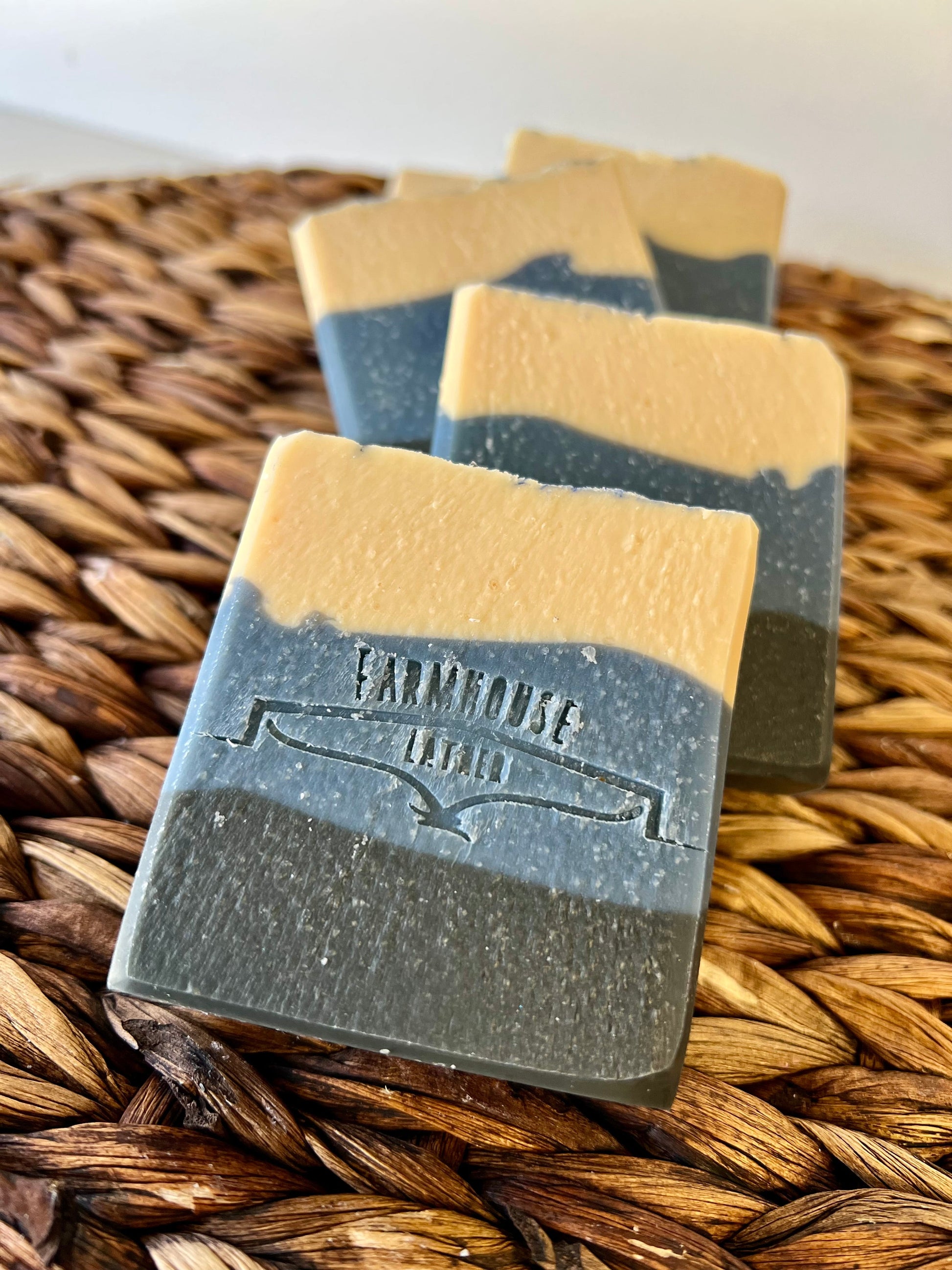 Stacked blue and cream soap bars with stamped label visible on front bar