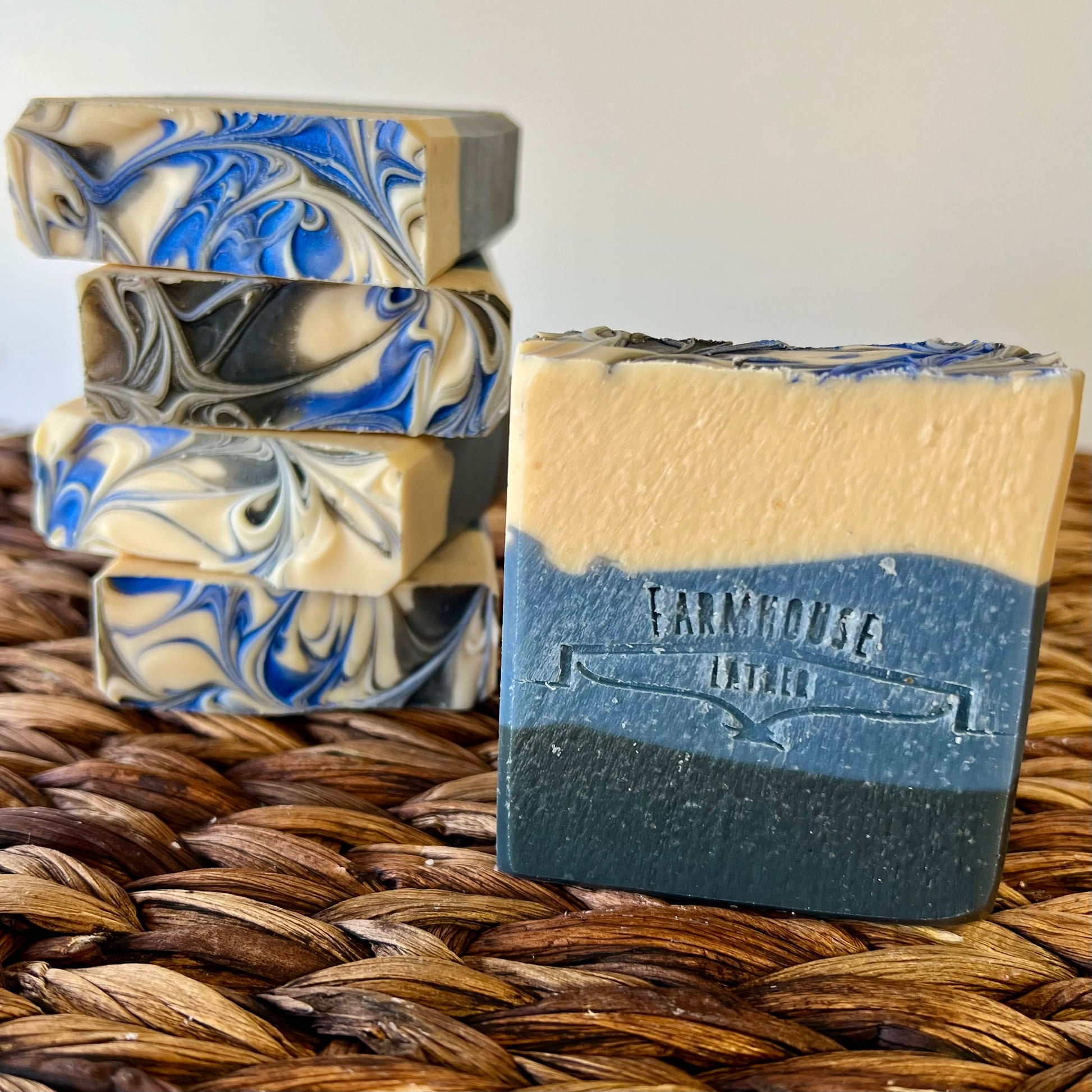 Soap bars with blue-and-cream swirls, one bar front with stamped label