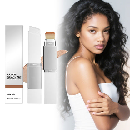Color-changing foundation stick with silver case and brush tip, shown with product box.