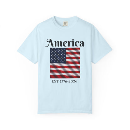 Light blue T-shirt with “America” over US flag and “EST 1776-2026” graphic on front
