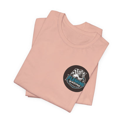 Peach crewneck T-shirt with small circular racing emblem on the chest, folded stack.