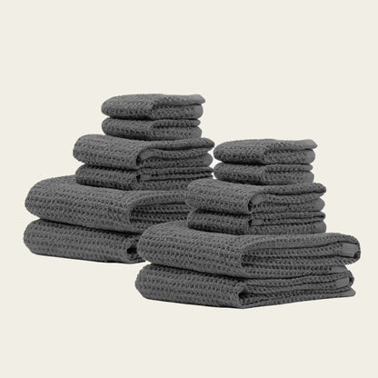Charcoal waffle towels stacked in two piles, folded with textured weave