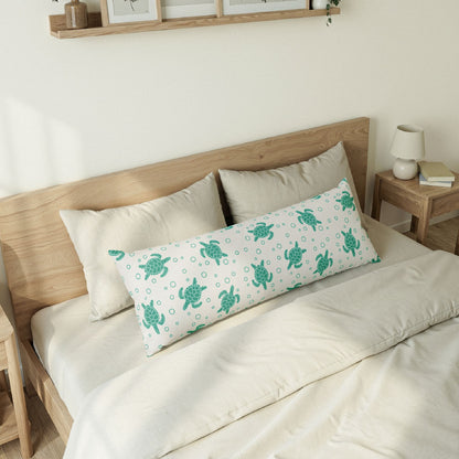 Body pillow on bed with teal sea turtle print and bubble dots on light fabric