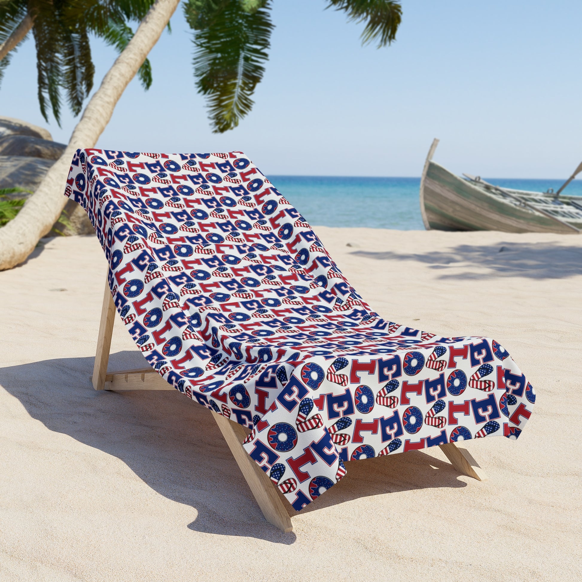 Beach towel folded on lounge chair, repeating LOL icons in red, white, and blue