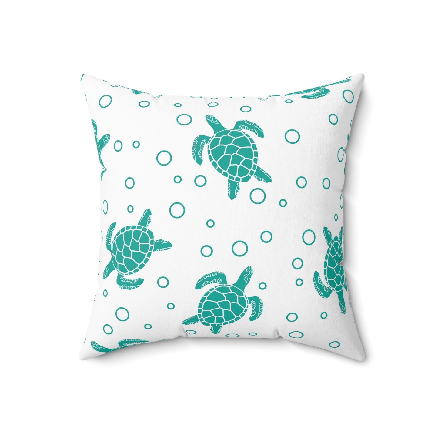 Square decorative pillow with teal turtle silhouettes and scattered teal circles on white cover