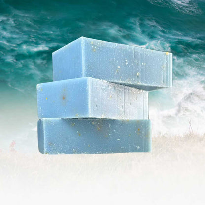 Organic bar soap, light blue rectangular bars with embossed label and speckles.