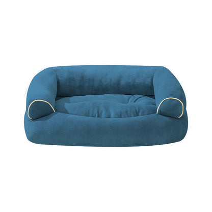 Blue fabric pet sofa bed with cushioned base and curved side bolsters, round shape.