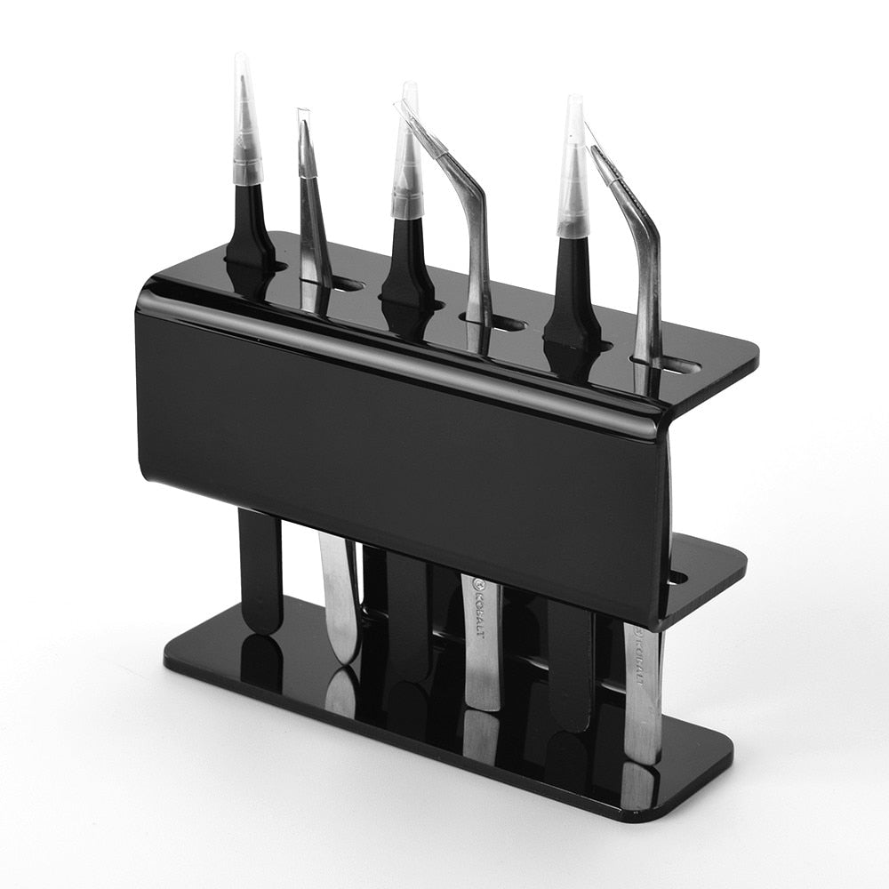 Black acrylic eyelash tweezer holder holding multiple lash tweezers