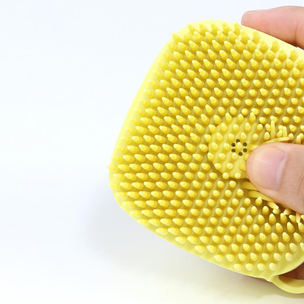 Yellow silicone-style dog bath brush pad with small raised cleaning bumps