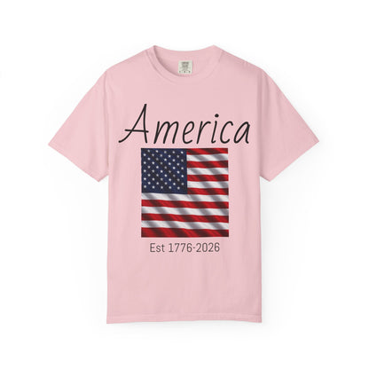 Pink unisex t-shirt with “America” script, U.S. flag, and “Est 1776-2026”