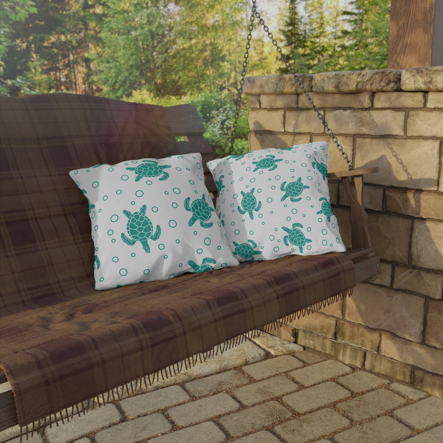 Pair of outdoor sea turtle pillows with teal turtles and dotted circle pattern