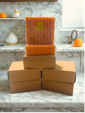 Quack of Dawn orange handmade soap bar with embossed floral design, stacked on boxes