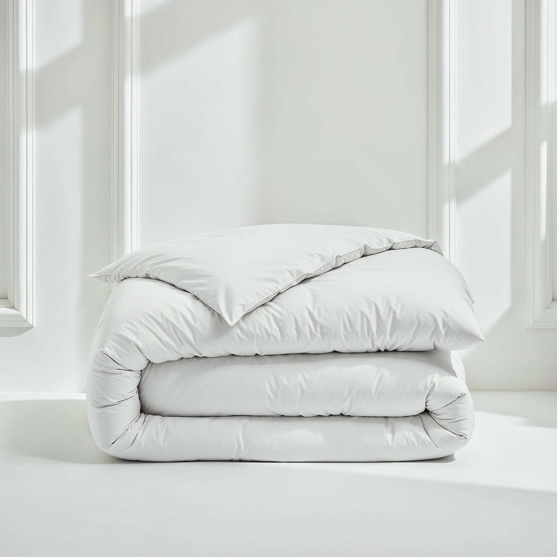 White sateen bedding bundle with a folded duvet and two pillows