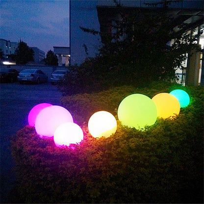 Outdoor LED garden ball lights with glowing purple, pink, yellow, cyan, and green spheres