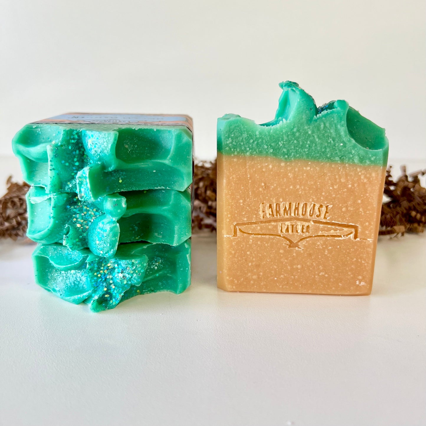 Goat milk soap bars, teal and tan, with decorative embossed surface
