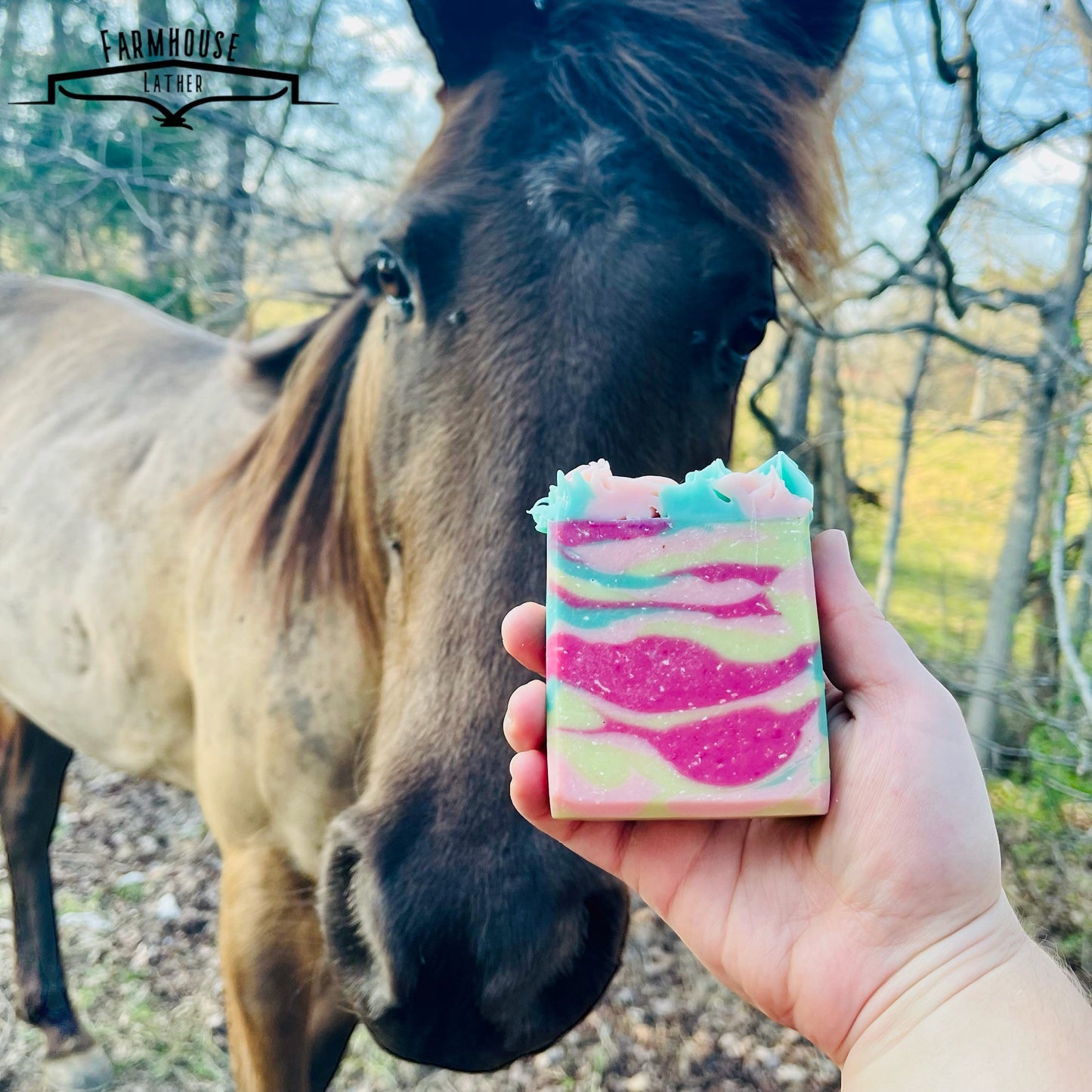 Country Garden striped soap bar, pink and teal layers, held in hand