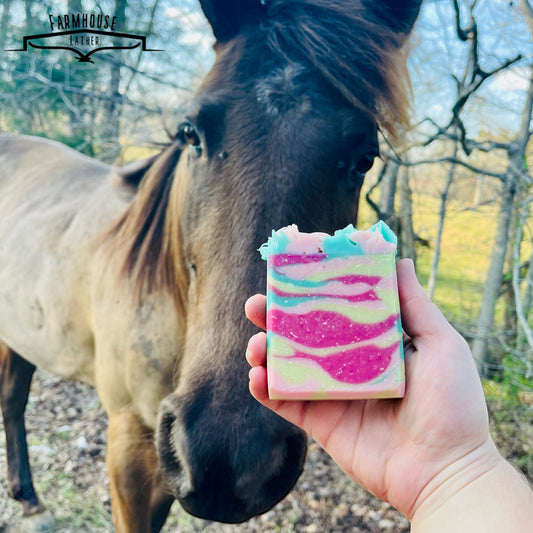 Country Garden striped soap bar, pink and teal layers, held in hand