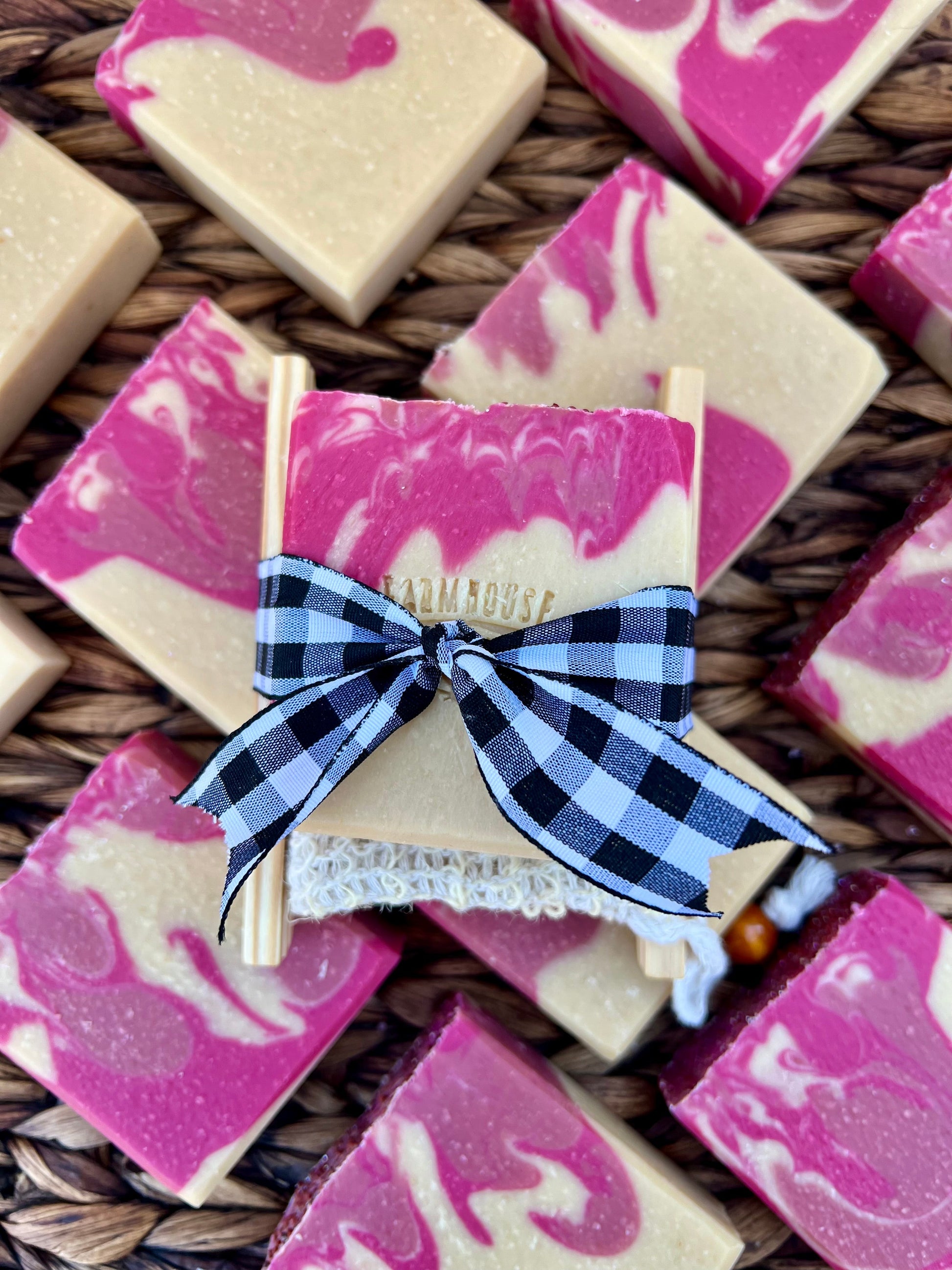 Pink and cream soap bar with blue plaid ribbon bow and white lace edges
