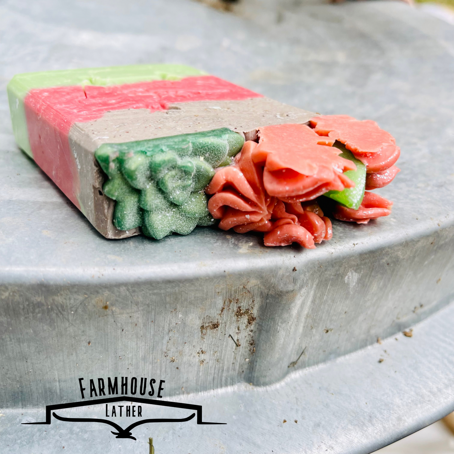 Layered soap bar with lime-green and pink layers, speckled gray, and rose-like toppers
