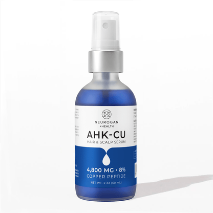 AHK-Cu hair & scalp serum bottle with blue liquid and white spray pump.