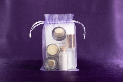Beauty gift set in a sheer drawstring pouch with jars and tubes