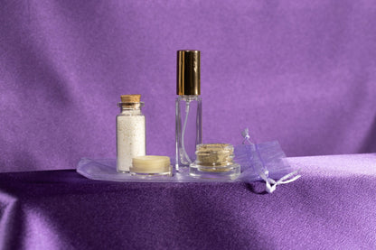 Skincare glow set with clear bottle and gold cap, white jar, and small cream jar