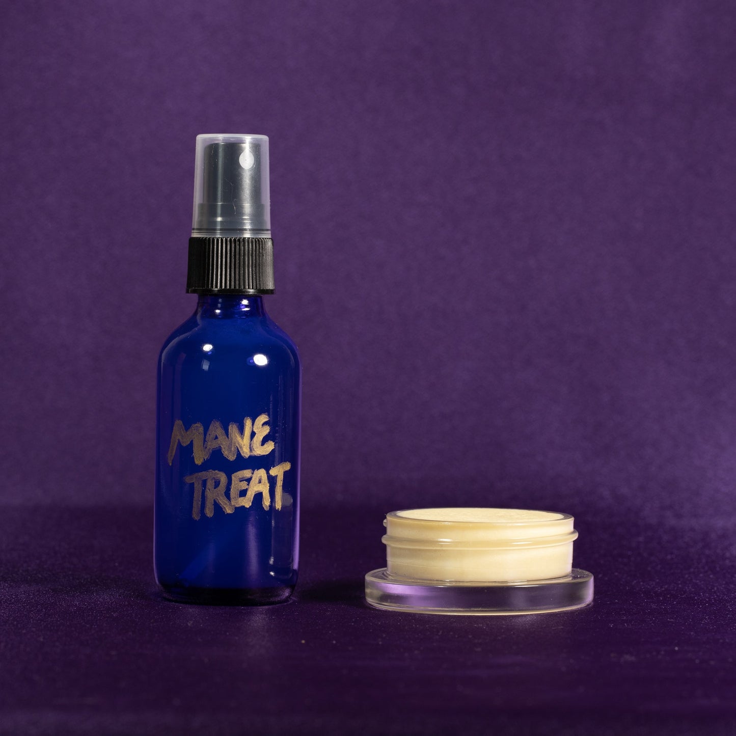 Blue Mane Treat spray bottle with silver nozzle and cream jar, front view