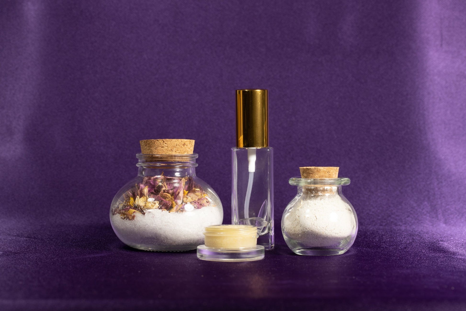Spa gift set with round salt jar, clear mist bottle, cream jar, and small glass jar