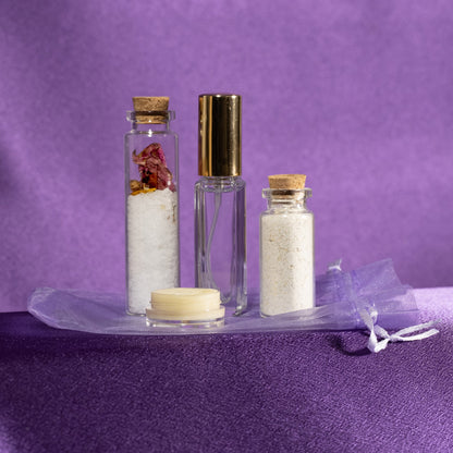 Spa gift set with glass bottles, salt jars, cream jar, and wrapped accessories
