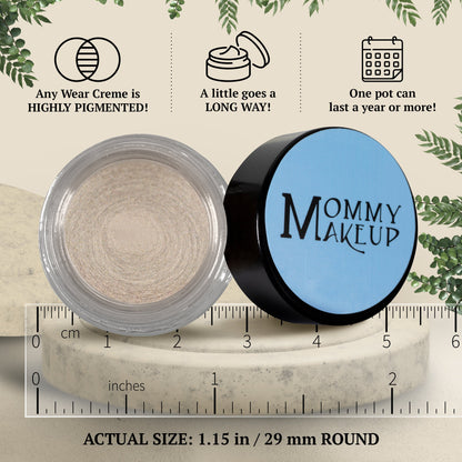 Round cream-to-powder shimmer pot in pale beige with icy sheen, closed and open
