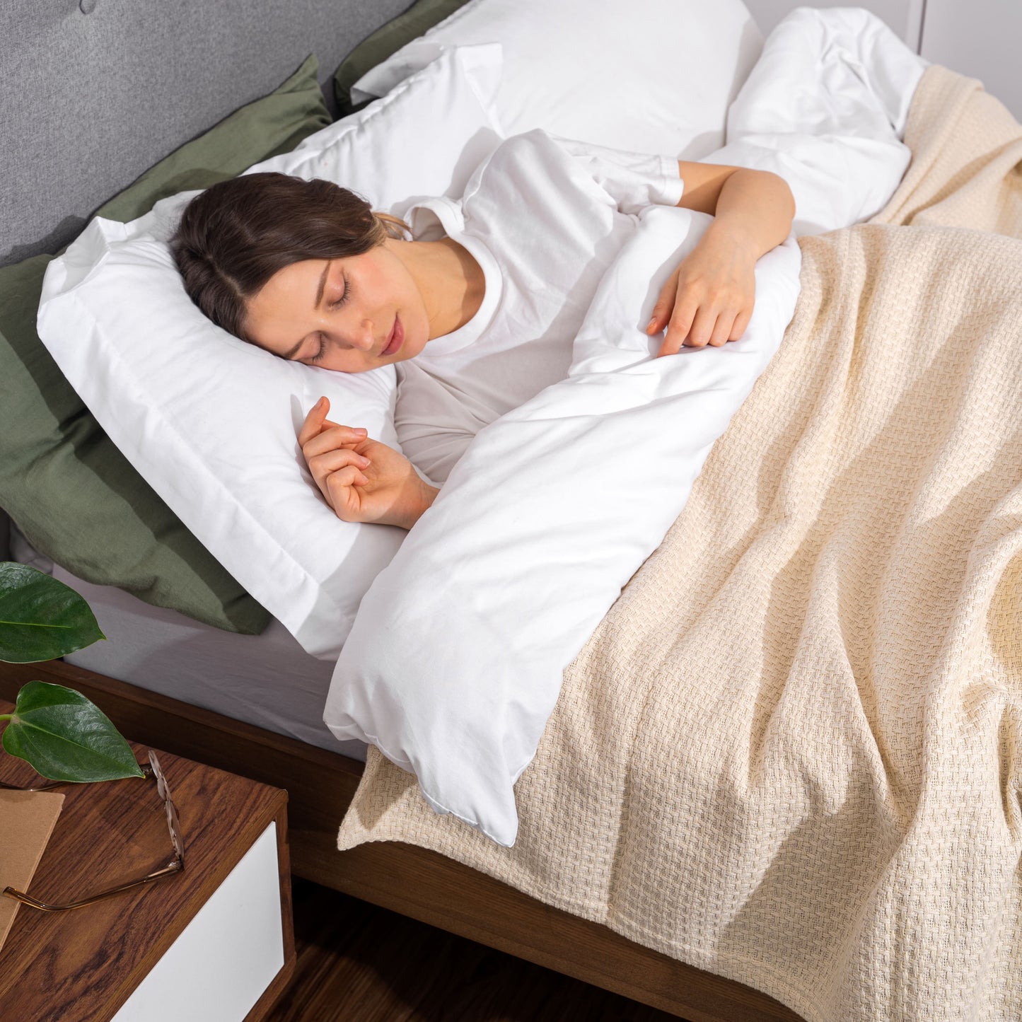 Beige basket-weave blanket covering bed with visible texture