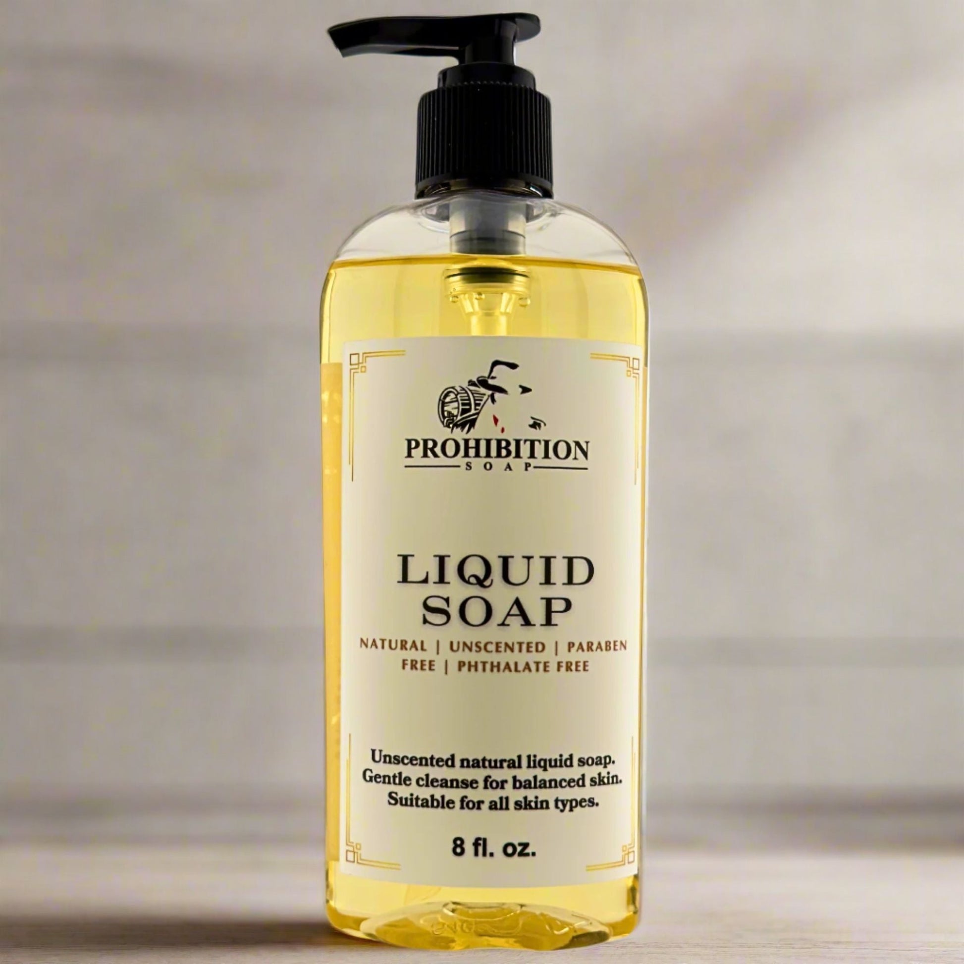 Liquid hand soap bottle with black pump, clear yellow liquid