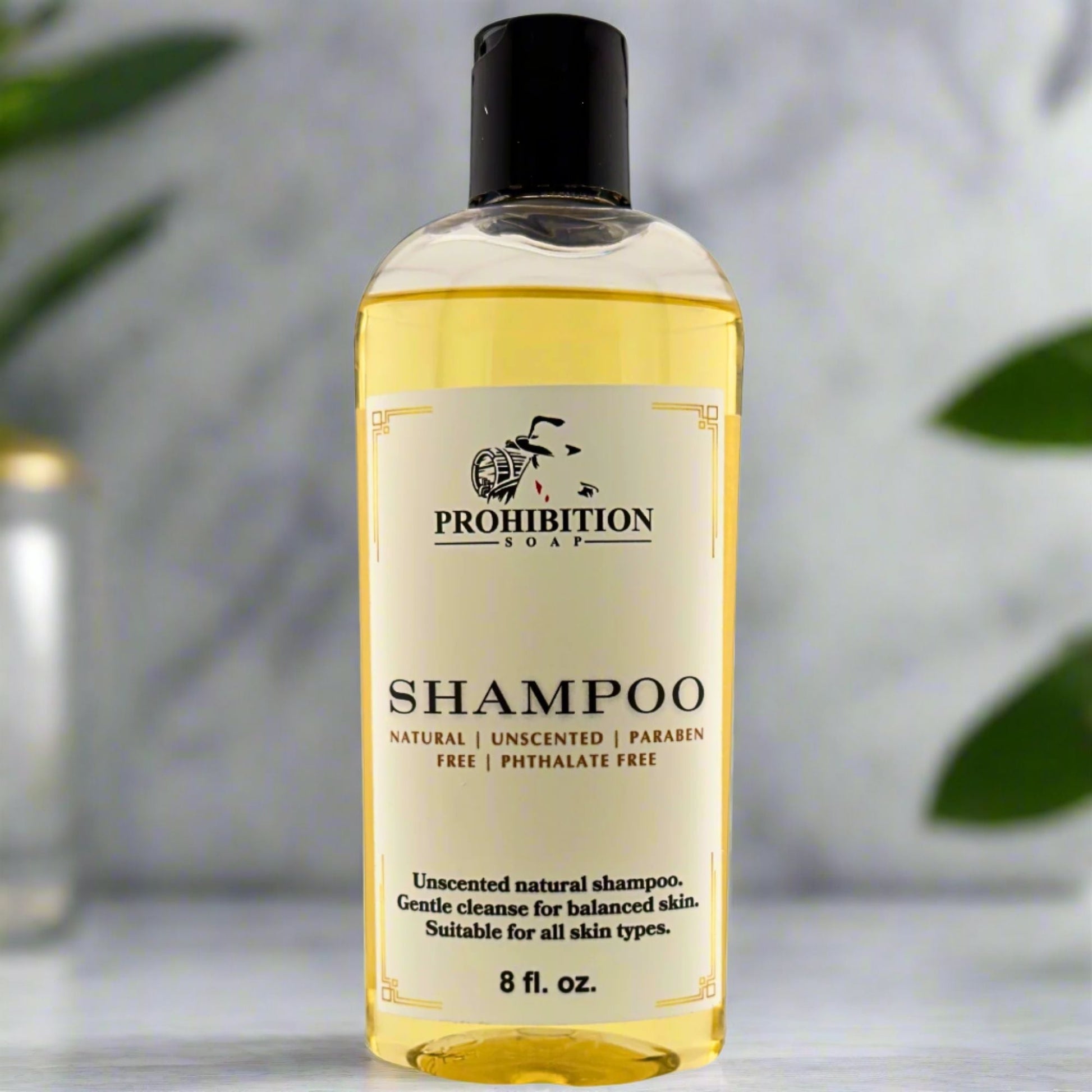 Shampoo bottle with black cap and yellow-gold front label, 8 fl oz