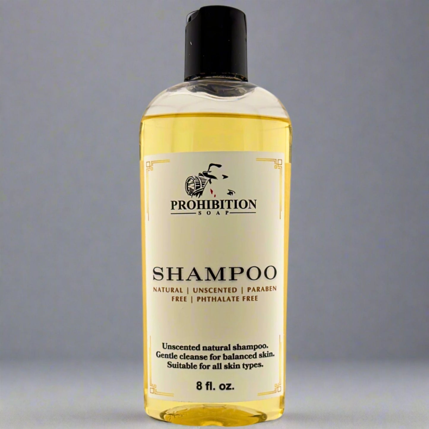 Shampoo bottle with black cap and yellow-gold front label, 8 fl oz